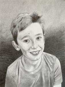 graphite drawing of boy smiling